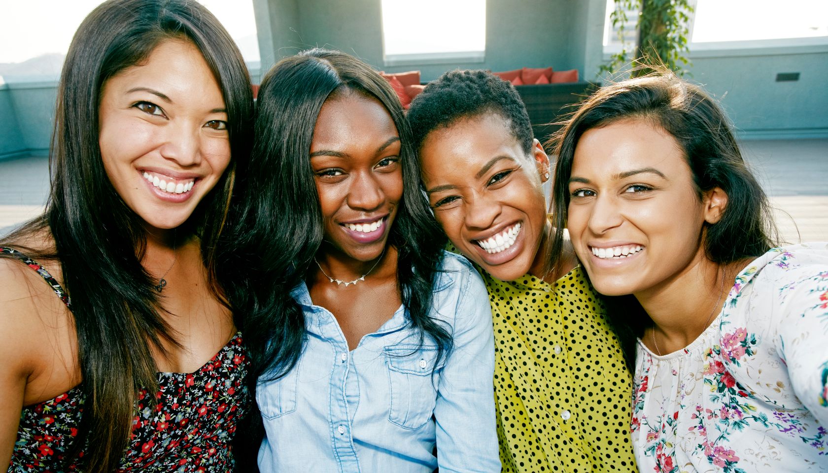 Smiling women posing on rooftop