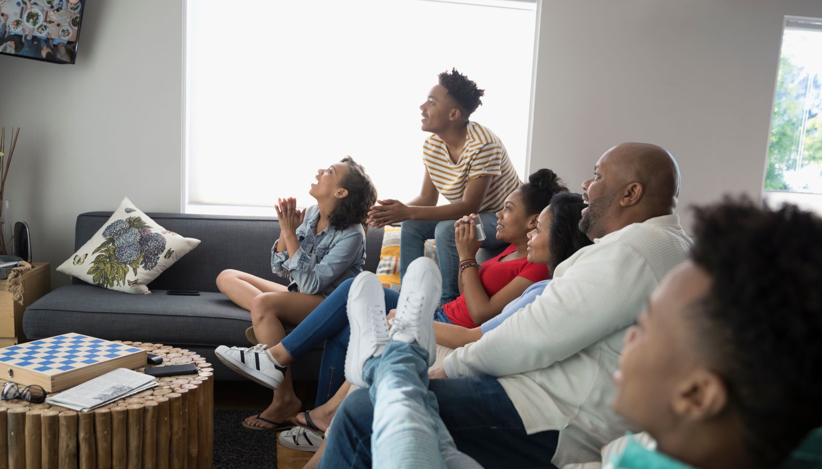 African American family watching TV in living room