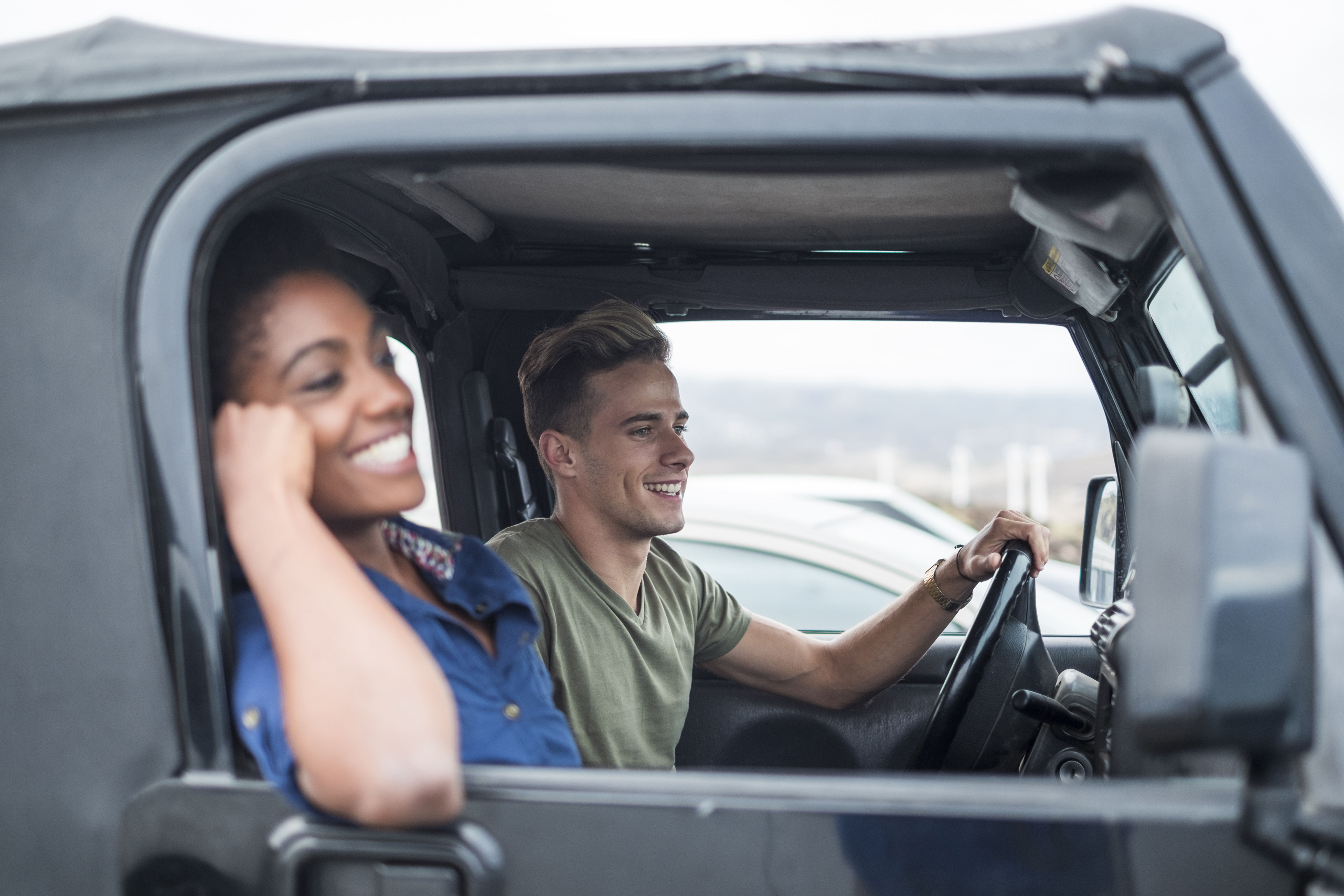 Happy young couple in a car