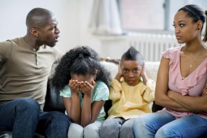 parents qurraling in front of children