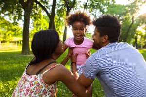 Playful African American family having fun in the park