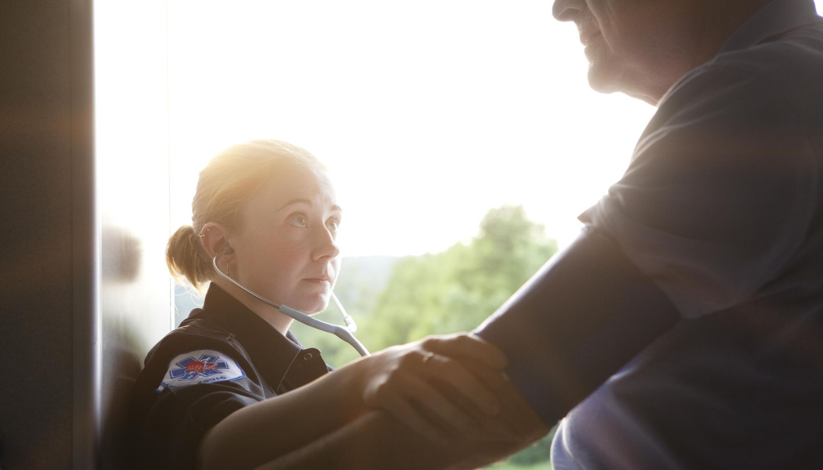 EMT Checking Blood Pressure of Senior Man