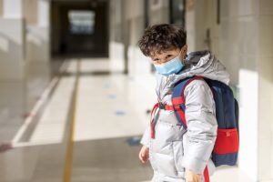 The pupil with a mask came out of the classroom