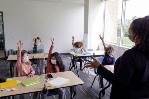 Multi-ethnic group of children wearing protective face masks at school