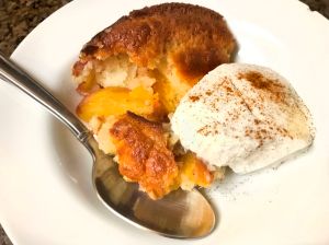 Bowl of peach cobbler and ice cream