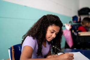 Girl taking notes in the classroom