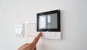 Hand pressing the air conditioner temperature adjustment switch