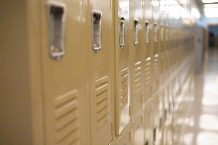 diminishing perspective of row of traditional metal school lockers