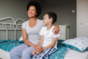 Mother and son sitting on the bed