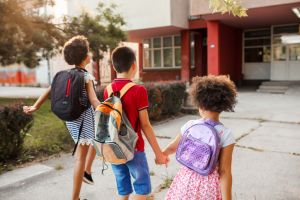 Three elementary school friends going to school