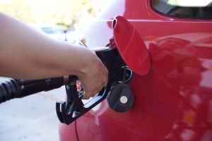 Anonymous girl refueling her car.