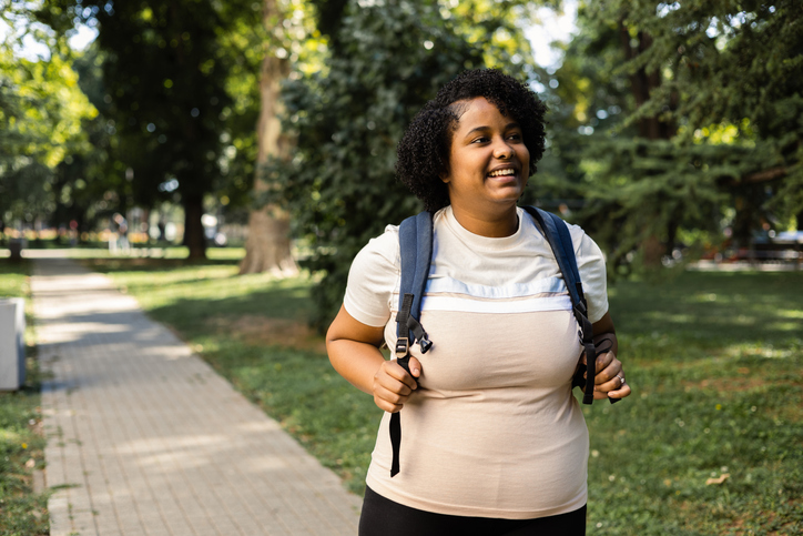 Portrait of a cheerful African American young woman in a walk