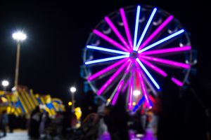 Illuminated Ferris Wheel In City At Night
