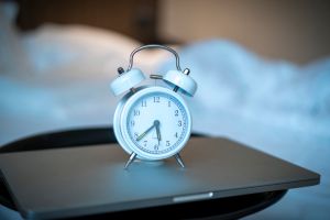 An alarm clock by the bed