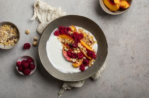 homemade breakfast muesli oat raspberry peach fruits and yogurt