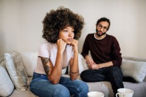Multiracial millennial couple at home discussing relationship difficulties