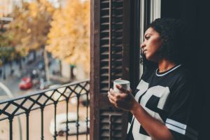 Woman in Barcelona drinking coffee at the balcony