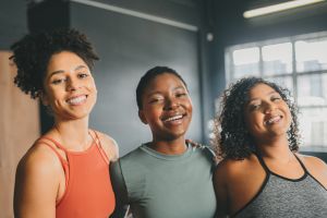 Fitness black women portrait in a gym studio with wellness goal, motivation and empowerment vision. Diversity people team, personal trainer or sports clients happy with exercise or training progress