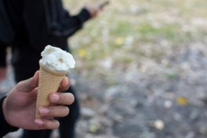 Hand Holding Ice Cream White On Blur Background.