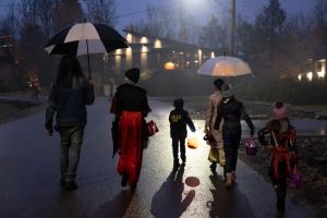 Group of People walking on illuminated street on Halloween night