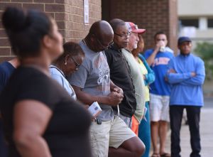 People wait in line to cast their ballots at the Orange...