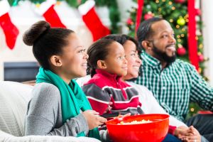 Happy African American family watch a Christmas movie