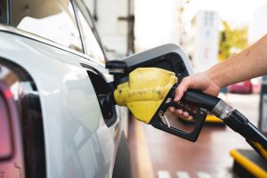 Closeup man filling up car in gas station