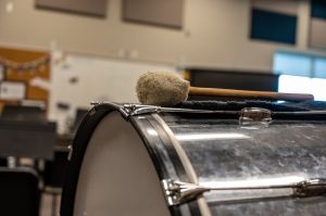 Selective focus on a marching band bass drum in a school room.
