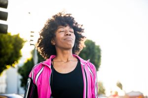 Young Fit Black Woman Listening to Music During Workout