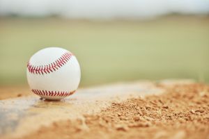 Baseball closeup, field and sports training outdoors for fitness, sport health and competition game. Athletic exercise equipment, softball motivation and match or baseball field bokeh background