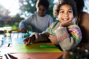 Happy black girl enjoying in creative time on a terrace.