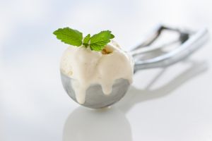 Scope of homemade vanilla ice cream in a metal spoon