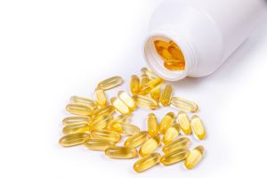 Medical pills spill out of a white jar on an isolated on white background,Oradea,Romania