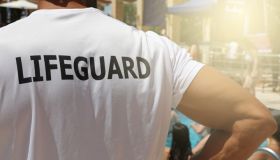 Lifeguard on duty at swimming poll. Saving life concept.