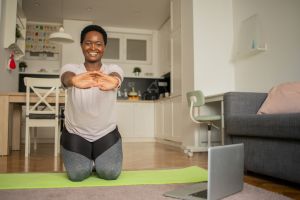 Young woman at home keeping fit by exercising
