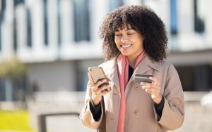 Credit card, city or woman with phone on online shopping for payment, internet purchase or ecommerce in London street. Fintech, happy or employee girl on 5g smartphone for trading, banking or invest