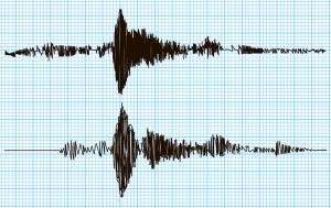 Double seismogram of seismic activity or lie detector record on blue chart paper