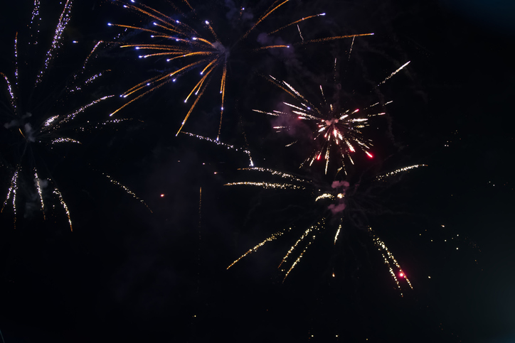 On a black background bokeh from explosions of colorful fireworks.