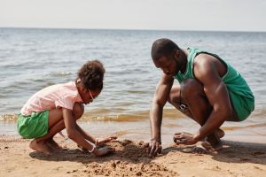 Dad building sand castle with daughter