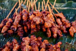 Close-up view of grilled chicken meat on banana leaf at street market,Phiman,Thailand
