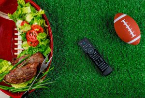 Appetizers on the plate with tv remote controller for the football party.