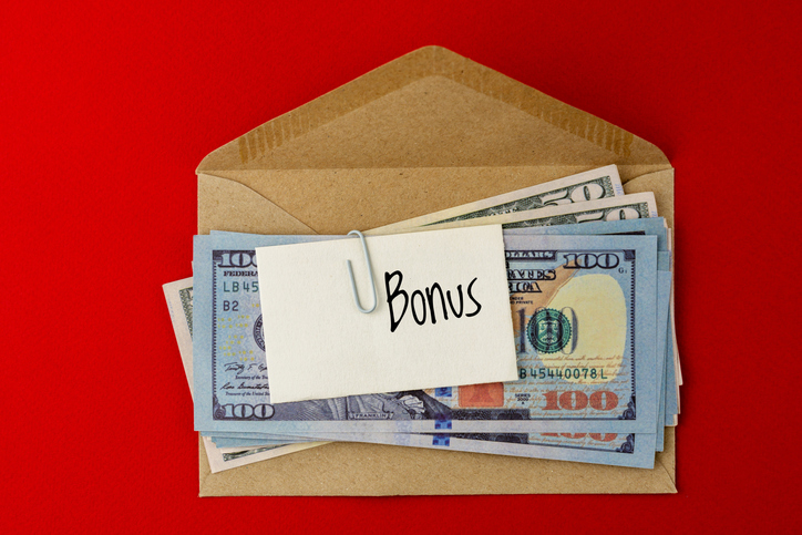 Paper Currency and Brown Envelope with Text Bonus on Paper Note