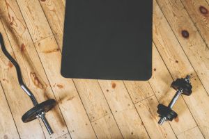sport concept. Top view of dumbbell and barbell exercise mat in the gym.