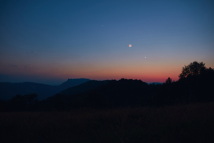 Crescent Moon, planet conjunction and landscape scenery silhouettes.