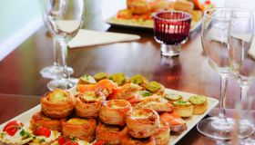 Party food on table with champagne glasses, copy space