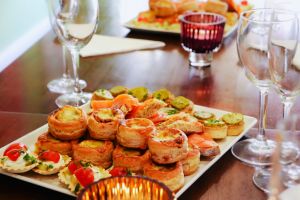 Party food on table with champagne glasses, copy space