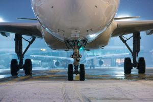 Winter frosty night at airport during snowfall