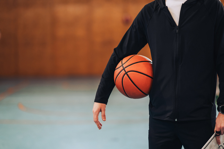 Basketball tucked under player's arm