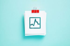 Line Graph Shaped Cut Out Post It Notes On Blue Background
