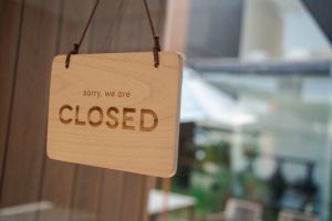 Closed message on wood tag in a glass door
